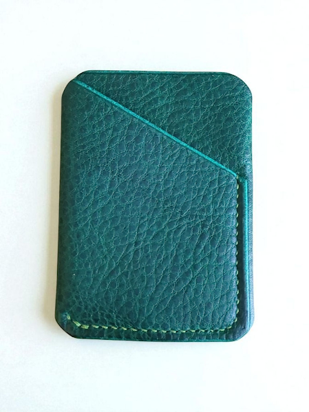 Green leather cardholder on a white background