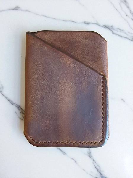 Rugged Brown leather wallet on a marble surface