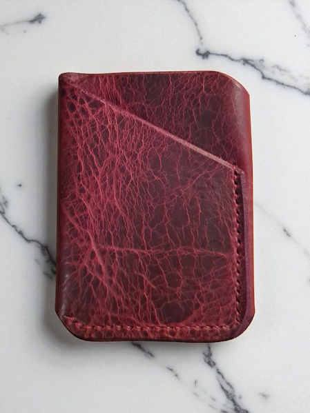Red Bison leather wallet on a marble surface