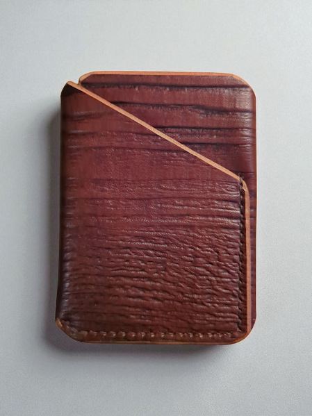 Wood grain leather wallet on a light gray background
