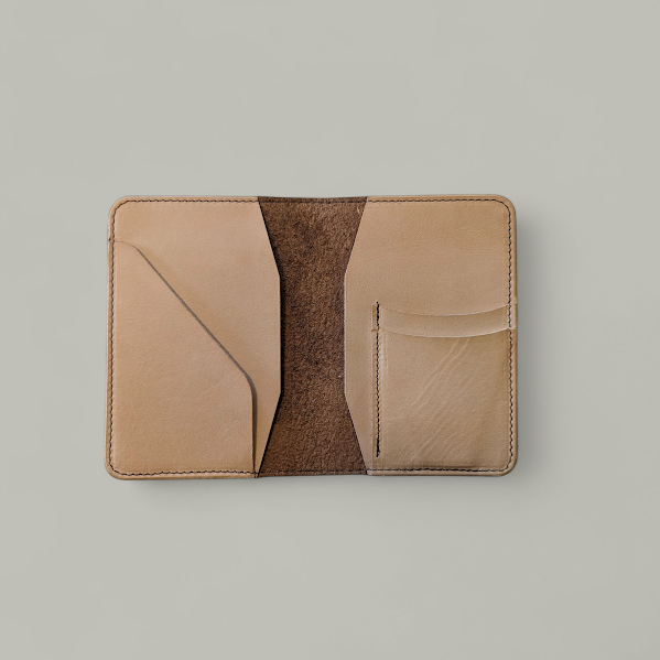 Two-tone leather wallet with beige and brown colors on a light gray background