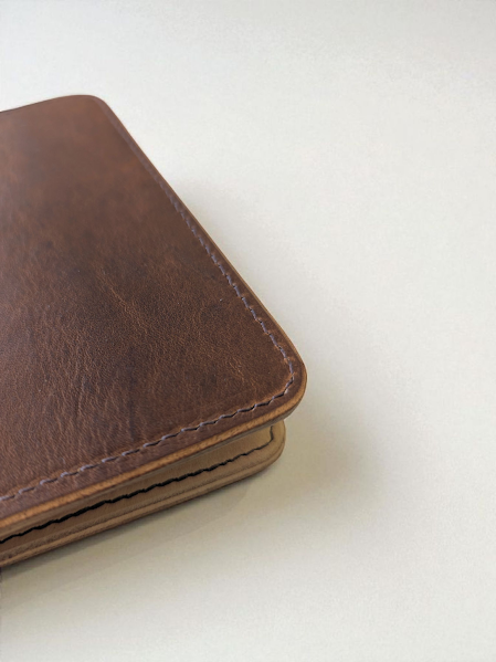 Brown leather passport cover on a white background