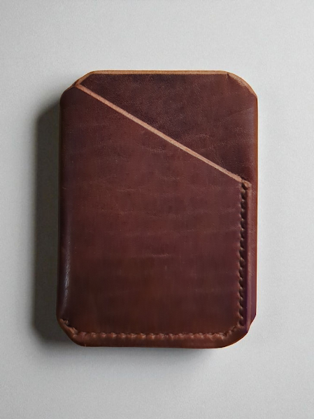Brown leather wallet on a light gray background