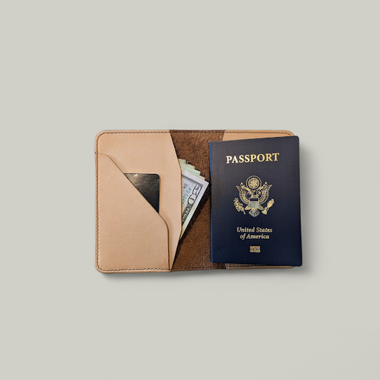 Passport and money in a leather wallet on a light gray background